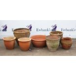 Collection of seven terracotta garden planters, to include one of urn form with twin handles,