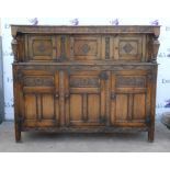 Jacobean style court cupboard floral carved frieze over 4 cupboards and carved and turned column