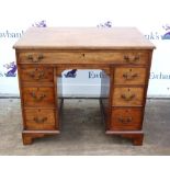 19th century mahogany desk with a single drawer and six short drawers on bracket feet,