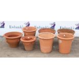 Collection of seven terracotta garden pots, including three matching pots marked Yorkshire