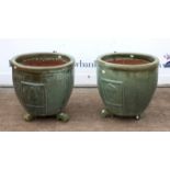 Pair of celadon glazed circular terracotta planters, with vignettes of trees, each on three