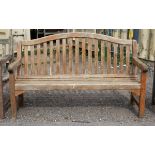 Teak garden bench of slat construction, on square legs joined by stretchers, h93cm w150cm d59cm