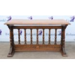 Late 19th century oak table on carved twin-end supports and balustrade stretcher,