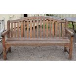 Teak garden bench of slat construction, on square legs joined by stretchers, h93cm w150cm d59cm