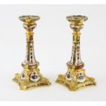 Pair of Royal Crown Derby 'Old Imari' pattern table candlesticks, each on a shaped square base,