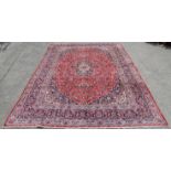 Large Persian red ground Kashan carpet, with traditional Kashan design, central floral medallion