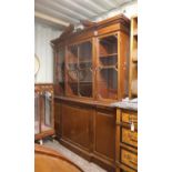 Early 20th century mahogany breakfront bookcase, with astragal glazed doors over slide and three