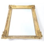 Late 19th century gilt framed mirror with scrolling decoration, overall size h86.5 x w58cm,