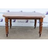 Victorian mahogany wind out dining table, extending to receive two extra leaves on turned fluted