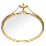Late 19th century oval giltwood wall mirror, with torchere finial and trailing harebells,