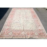 Agra carpet, central floral medallions and vine decoration on a beige ground, within scrolling