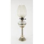 Silver plated oil lamp by Hukin & Heath with scrolling foliate decoration and cut glass reservoir,
