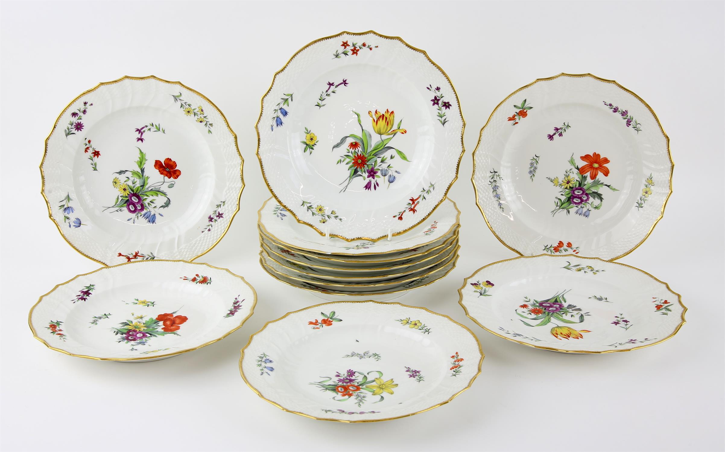 Twelve Royal Copenhagen porcelain plates, hand-painted with varying blossoming flowers and with