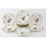 Twelve Royal Copenhagen porcelain plates, hand-painted with varying blossoming flowers and with