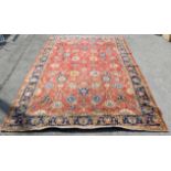 Persian carpet with palmettes and floral motifs on a red ground, within blue ground border with