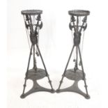 Pair of cast iron torcheres in the form of three crossed pikes and shields with hanging maces,
