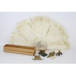 Ostrich feather fan with mother of pearl sticks, early 20th century ivory dog whistle,
