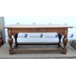 Late 19th century oak refectory table, with a single drawer, on turned baluster supports joined by