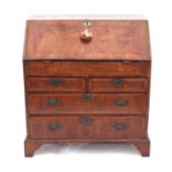 George II walnut bureau with herringbone cross-banding, flap enclosing cupboard flanked by secret