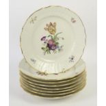 Eight Royal Copenhagen plates painted with blossoming flowers, basket weave borders,