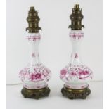 Pair of continental porcelain lamps with garlic bulb necks with pink and gilt floral decoration