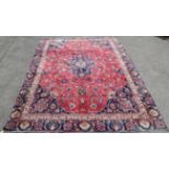 Large Persian Mashad red ground carpet, with central floral medallions and scrolling floral design