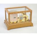 A modern cased barograph by Sewills of Liverpool. Height 18cm, width 28cm, depth 20cm.