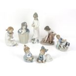 Collection of Lladro and Nao figurines, to include a Lladro dog in a basket, a Lladro figurine of a