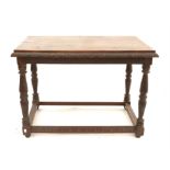 Oak table with rectangular top on turned and carved supports united by carved peripheral stretcher,