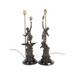 Pair of spelter figural lamps, with a man holding a torchere and a lady holding a star while both