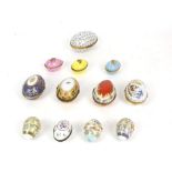 Collection of French hand painted porcelain and gilt high-lighted eggs with scrolling decoration,