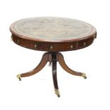 George III style mahogany drum table with four drawers and four dummy drawers on turned column and