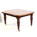 19th century mahogany extending dining table with 1 extra leaf on turned and reeded legs to casters