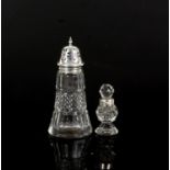 Large silver topped sugar castor and a silver collared scent bottle