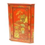 Red lacquered corner cabinet with Chinoiserie decoration of figures, pagodas and bats, h102.