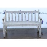 Weathered teak garden bench of slat construction on square legs, h84cm w122cm d53cm