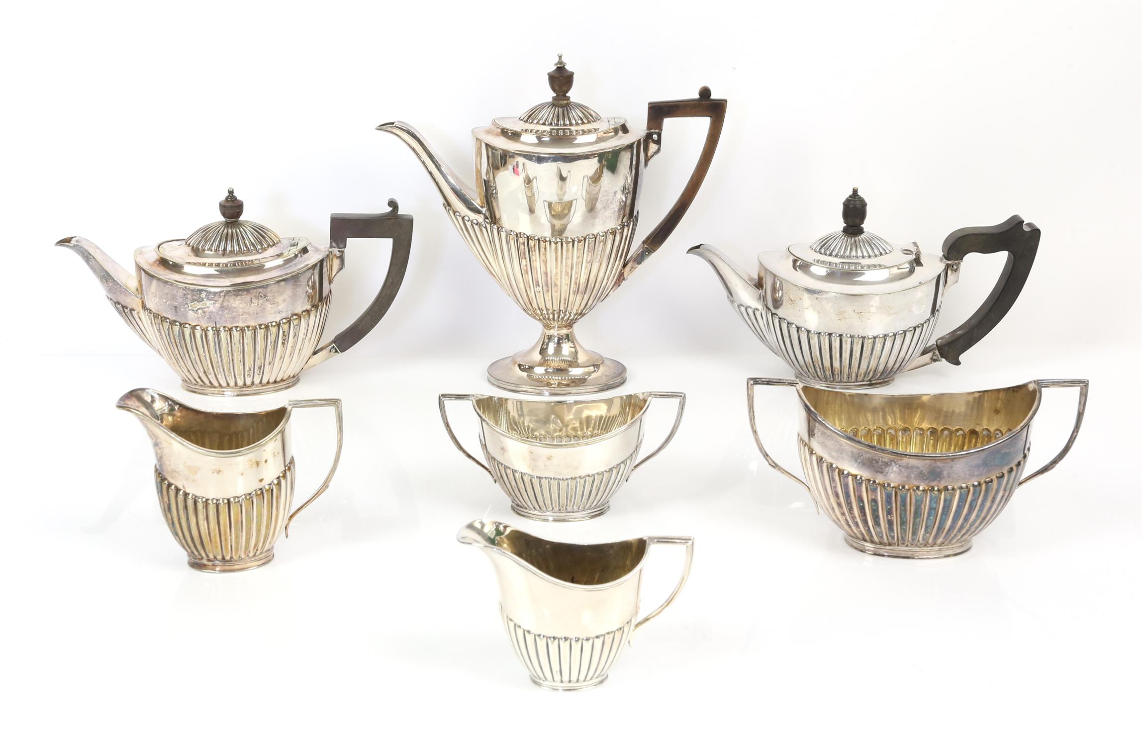 Four piece silver plated tea set and a three piece silver plated tea set both by Goldsmith and