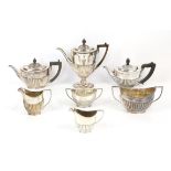 Four piece silver plated tea set and a three piece silver plated tea set both by Goldsmith and