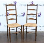 Two 20th century ladder back chairs with rush seats, together with a mahogany dressing table mirror,