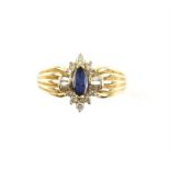 Sapphire and diamond ring with marquise cut sapphire and baguette and round brilliant cut diamonds