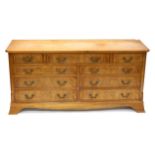 Modern walnut chest of two short and one long drawer over six long drawers on bracket feet,