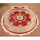 Chinese style floral decorated circular rug, with central floral medallion on a pink ground within