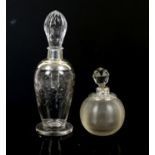 Two large silver collared perfume bottles, one with ribbed body design the other with etched star