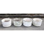 Set of four reconstituted white painted stone circular planters relief moulded with cherubs picking