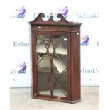 19th century mahogany corner cupboard, with broken swan neck pediment with central brass urn finial,