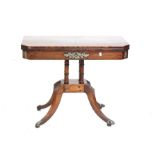 Regency mahogany foldover card table, on four column supports and quatrefoil base with lions' paw