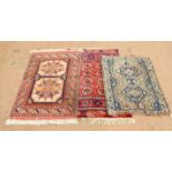 Three Persian rugs, to include a rug with two geometric medallions within a geometric and stylised