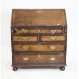 18th century oak bureau, the fall front revealing a fitted interior, with pigeon holes, cupboards,