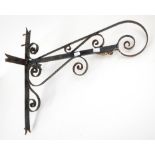 Cast metal wall bracket of pierced scrolling design, h55cm w27cm d57cm