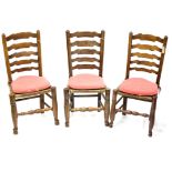 Set of six early 19th century ash ladder back chairs, with rush seats on turned legs,